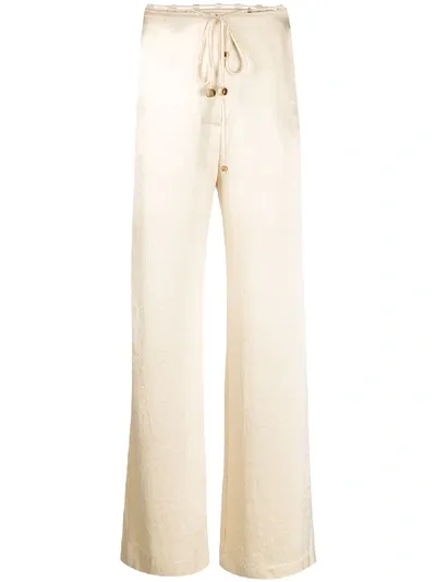 Nanushka Flax Satin Belted Trousers In Yellow