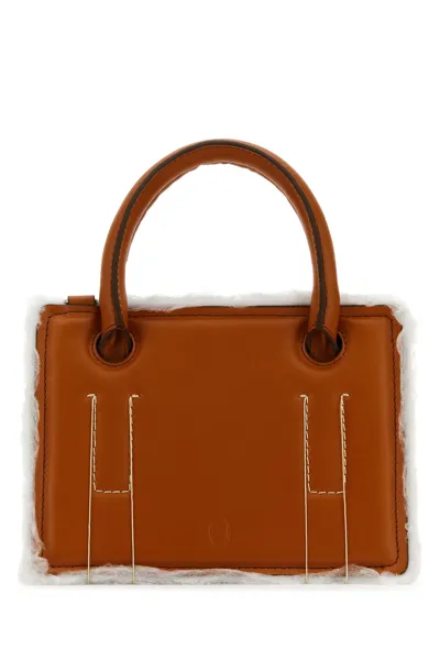 Dentro Handbags. In Brown