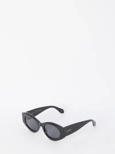 Alaïa Oval Sunglasses In Black