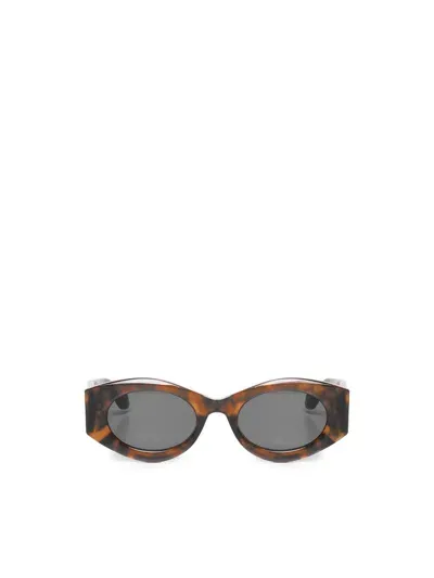 Alaïa Oval Sunglasses In Brown