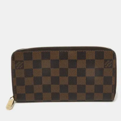 Pre-owned Louis Vuitton Damier Ebene Canvas Zippy Wallet In Brown