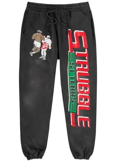 Saint Mxxxxxx Denim Tears Tapered Distressed Printed Cotton-jersey Sweatpants In Black